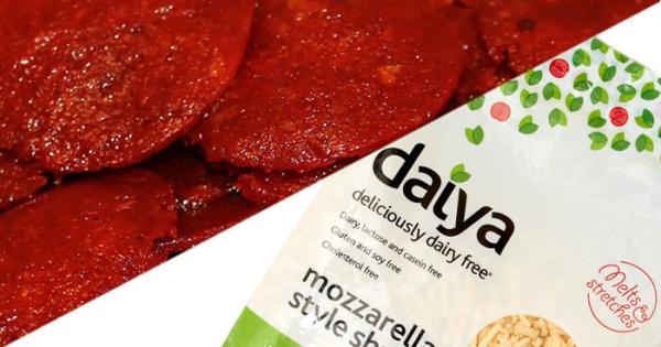 Close-up of pepperoni slices beside a Daiya mozzarella shreds packet