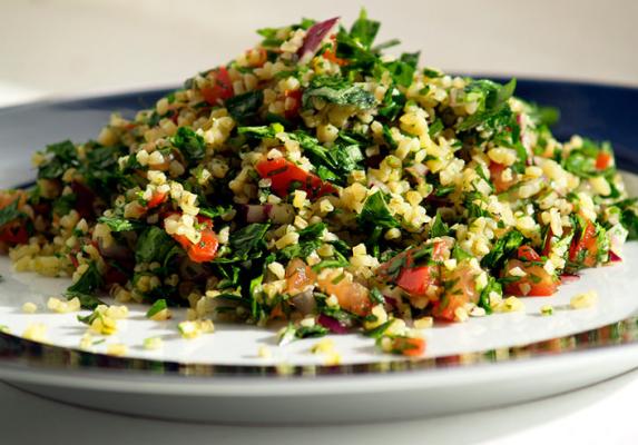Plate of fresh tabouli salad with parsley, bulgur wheat, tomato and herbs