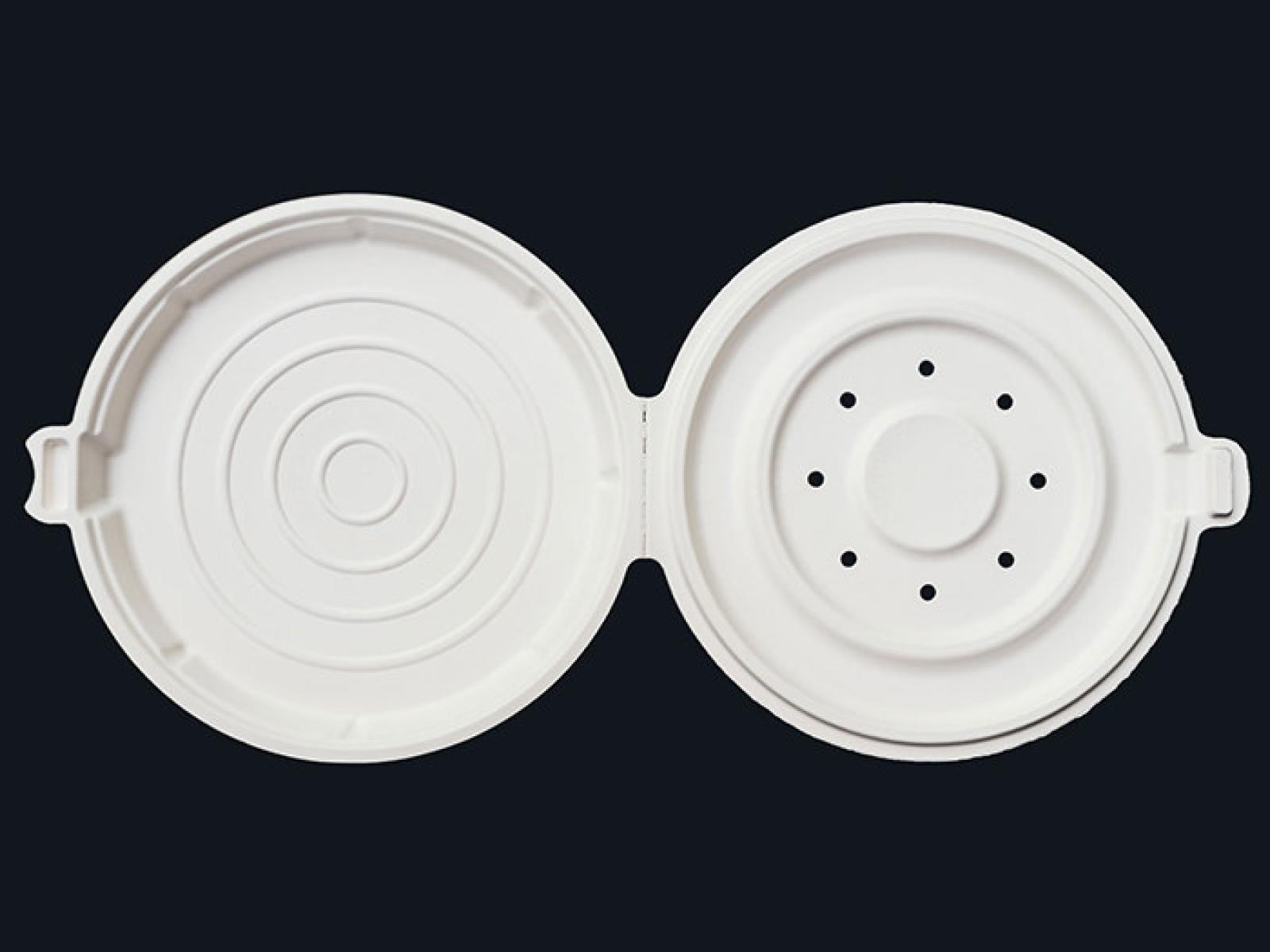 Open white plastic pizza box vent insert with circular grooves and air holes