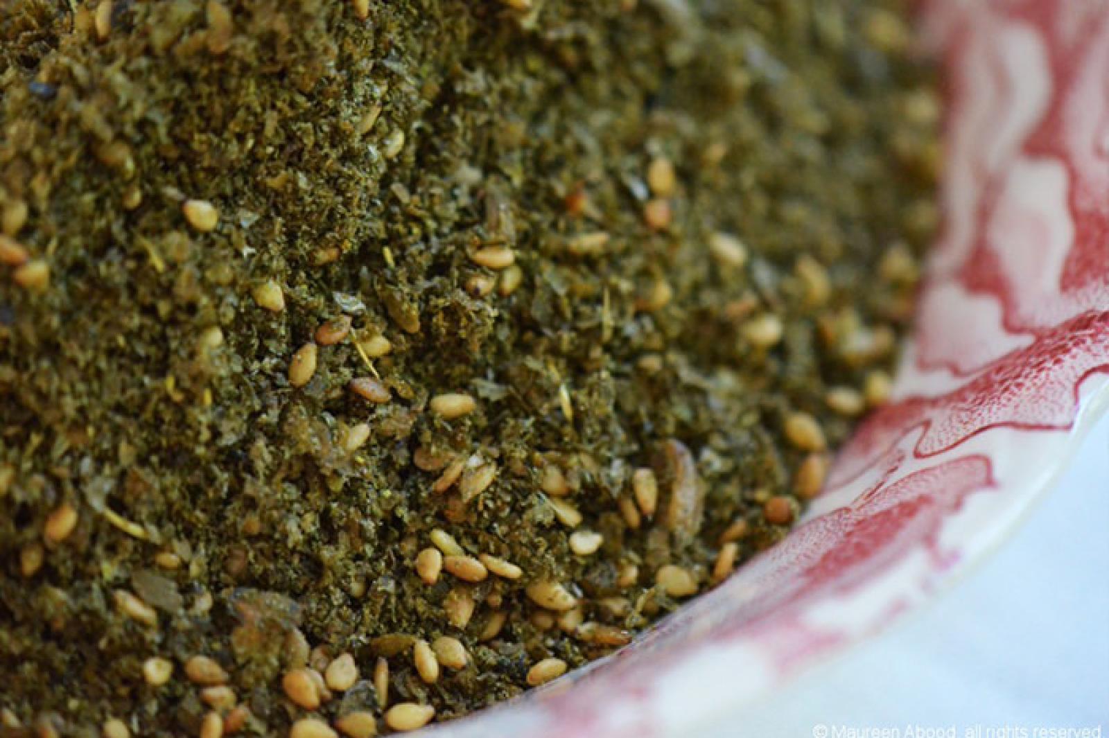 Close-up of zaatar spice blend with sesame seeds in a patterned bowl