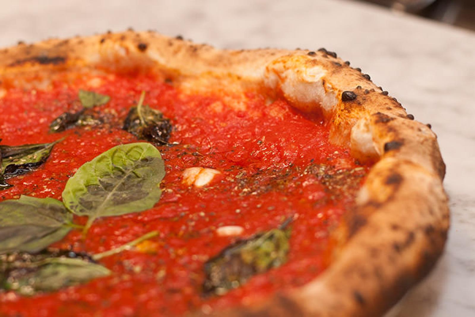 Close-up of a freshly baked Margherita pizza with tomato sauce, melted cheese and basil
