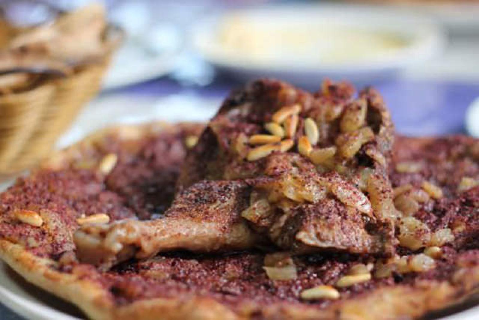 Lebanese meat pizza topped with spiced minced lamb and pine nuts