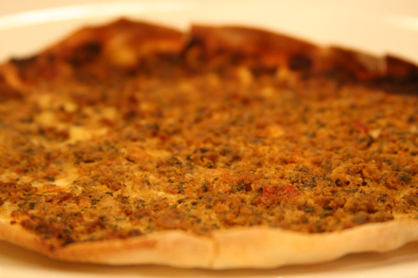 Close-up of a Lebanese lahembajin flatbread topped with seasoned minced meat