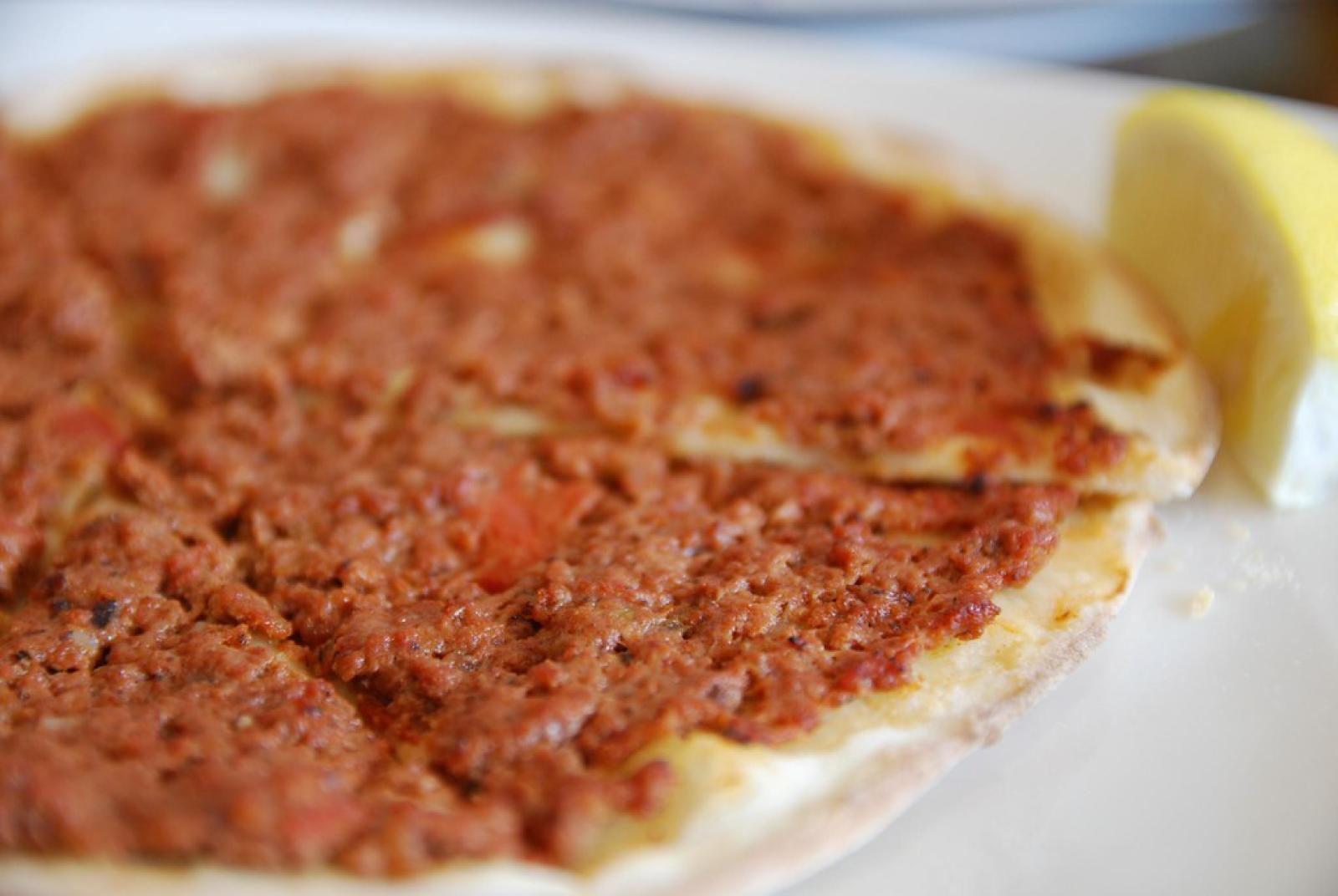 Close-up of Lebanese lahembajin flatbread topped with spiced minced meat and served with lemon