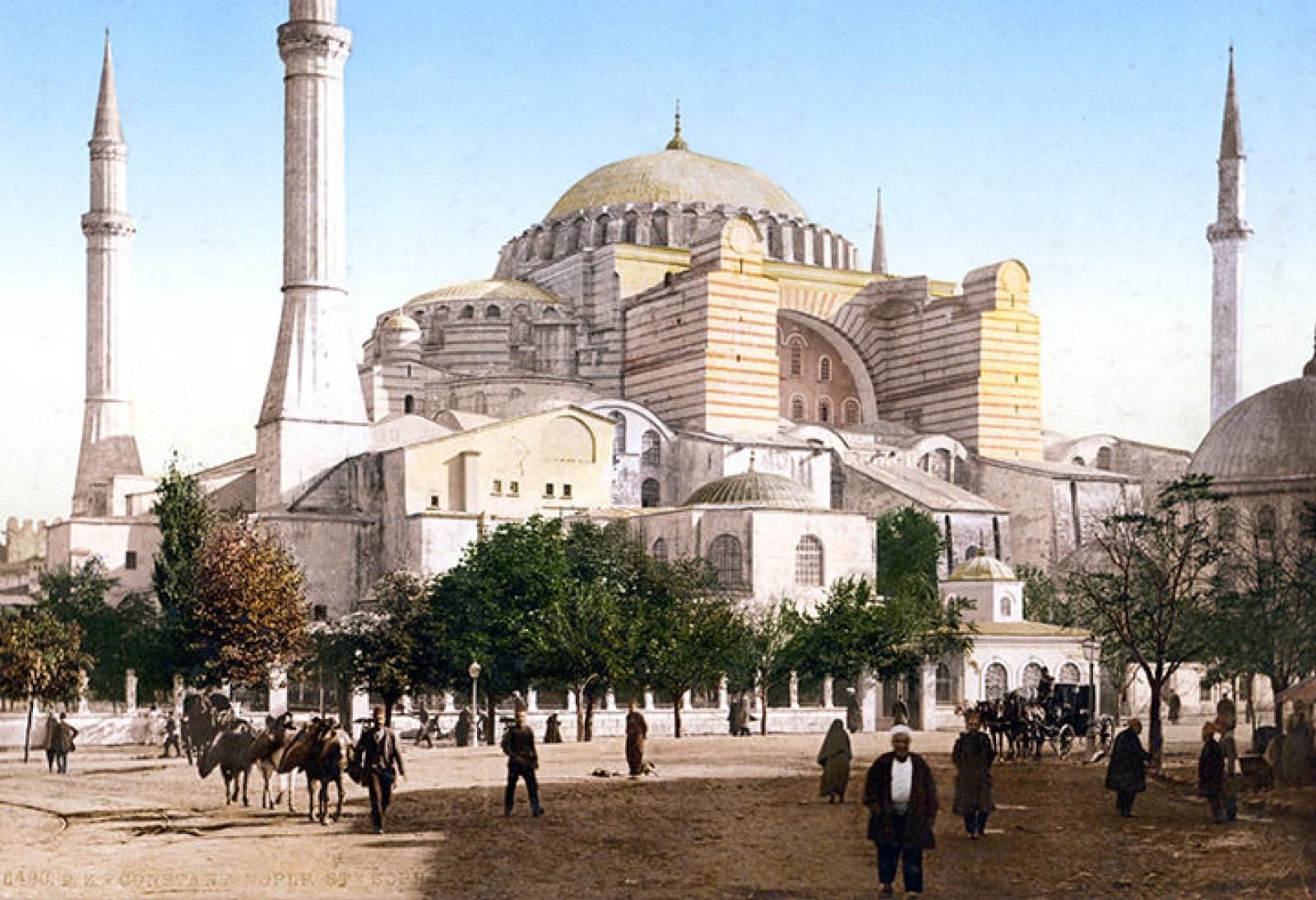 Historic view of Hagia Sophia mosque in Istanbul with minarets and people in the square
