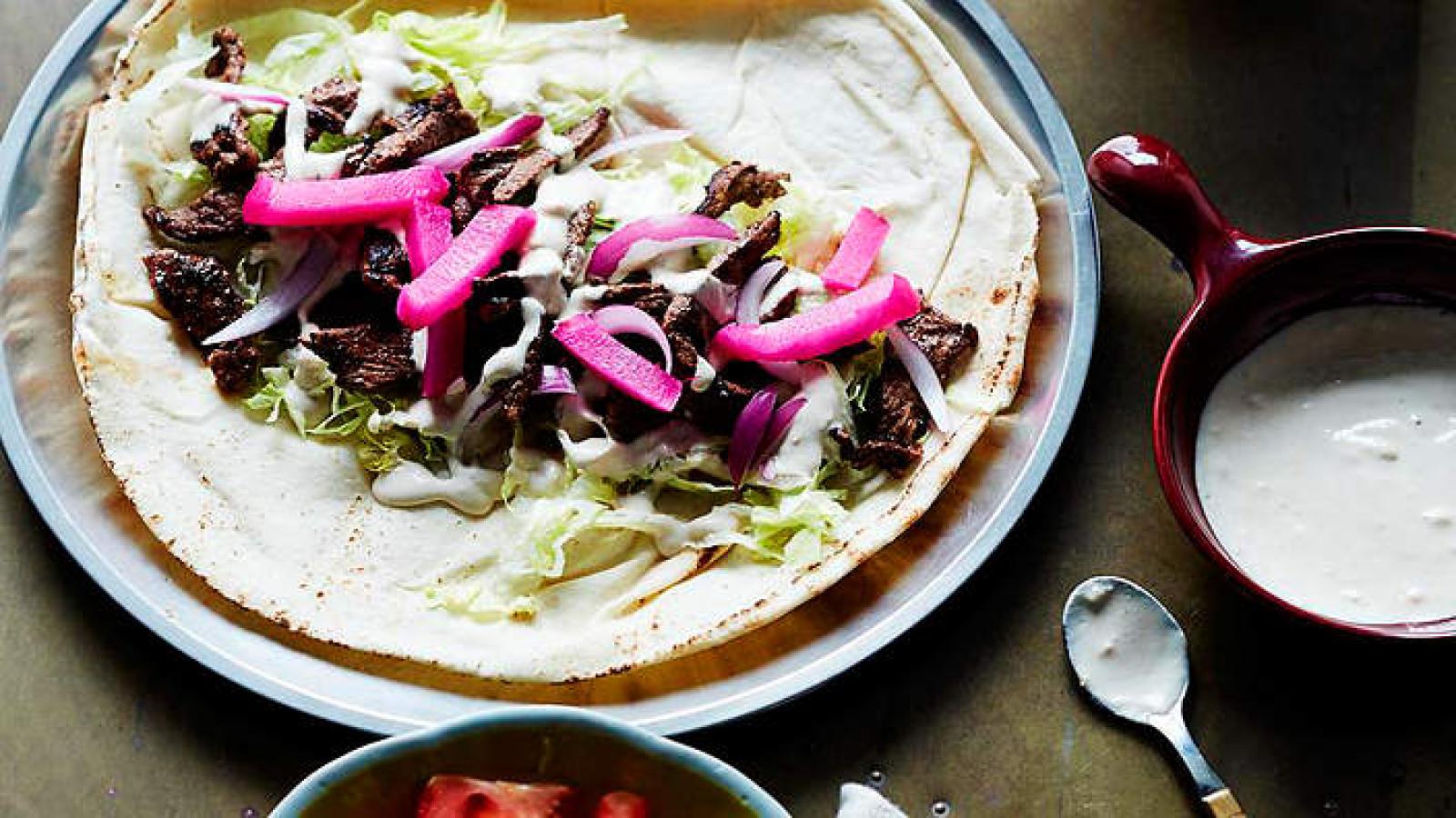 Lebanese flatbread topped with greens, sliced pickled turnips and a creamy sauce