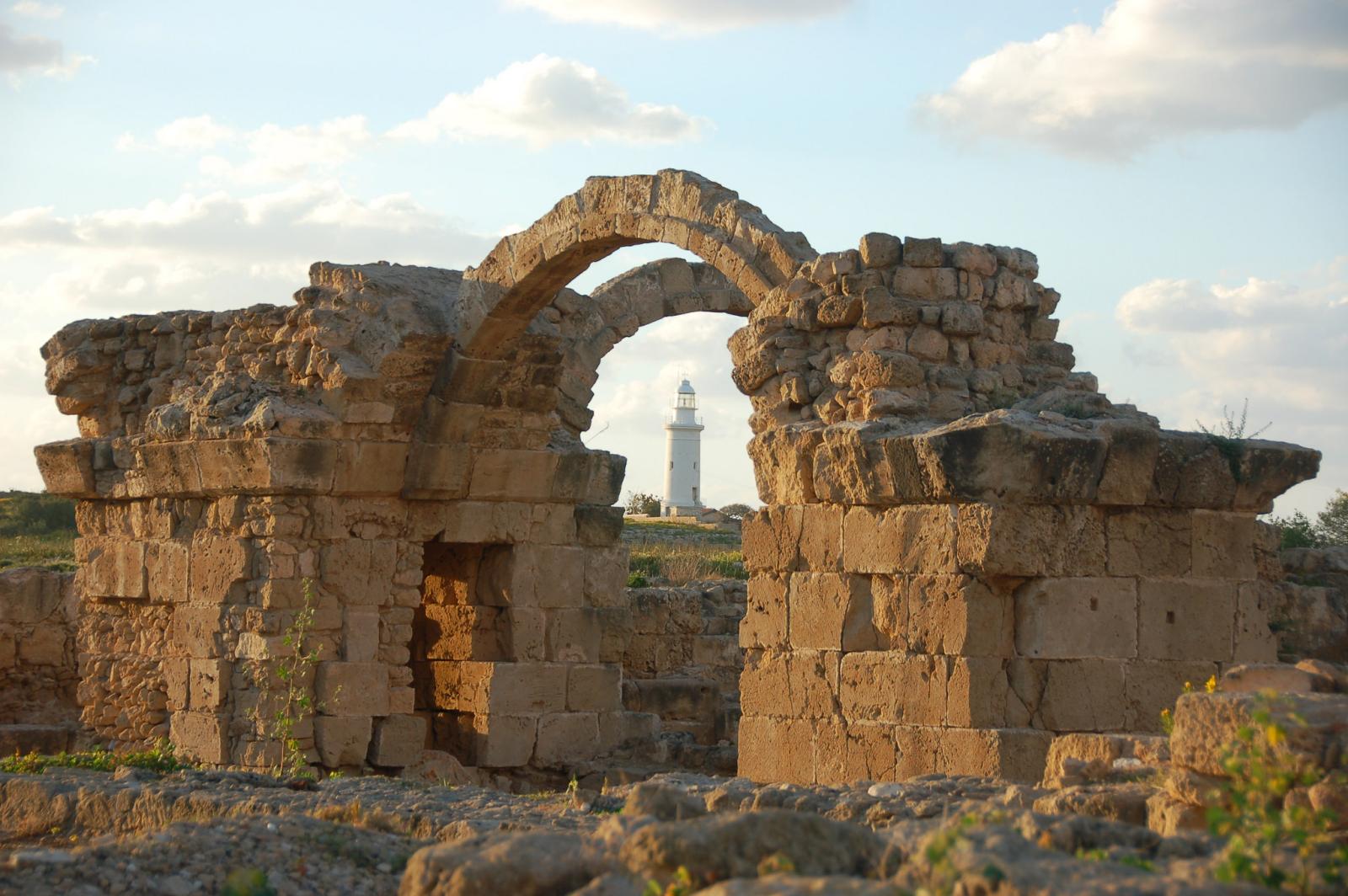 Ancient stone arch and temple ruins at Baalbek, Lebanon, beneath a partly cloudy sky